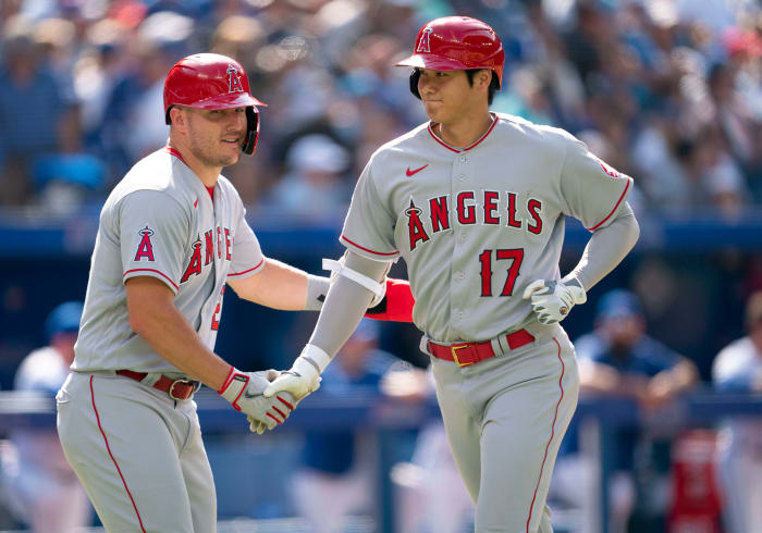 Mike Trout congratulates Shohei Ohtani after he hit a home run.